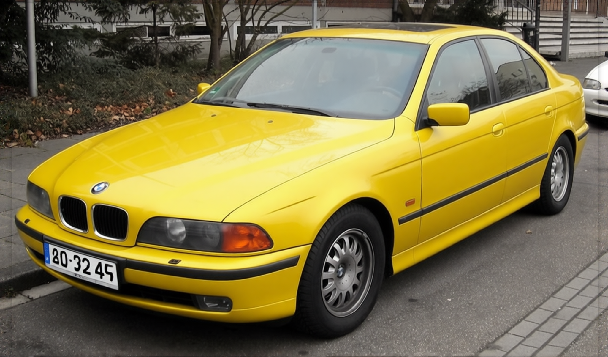 BMW 5 Series rendered in Racing Yellow gloss paint